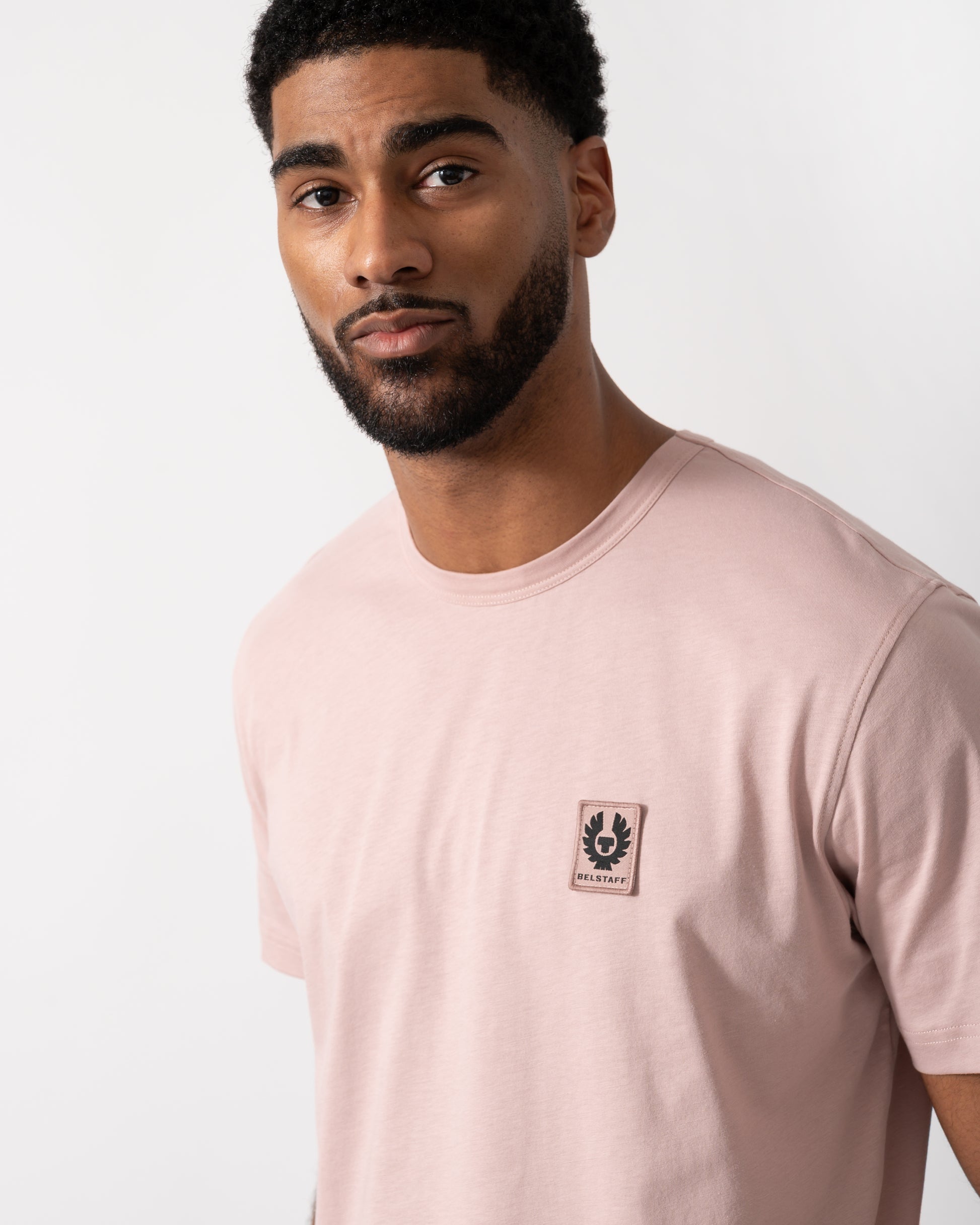 Close up shot of a Model wearing a Belstaff Short Sleeved Mens Logo Patch T-Shirt  in Dusk Pink