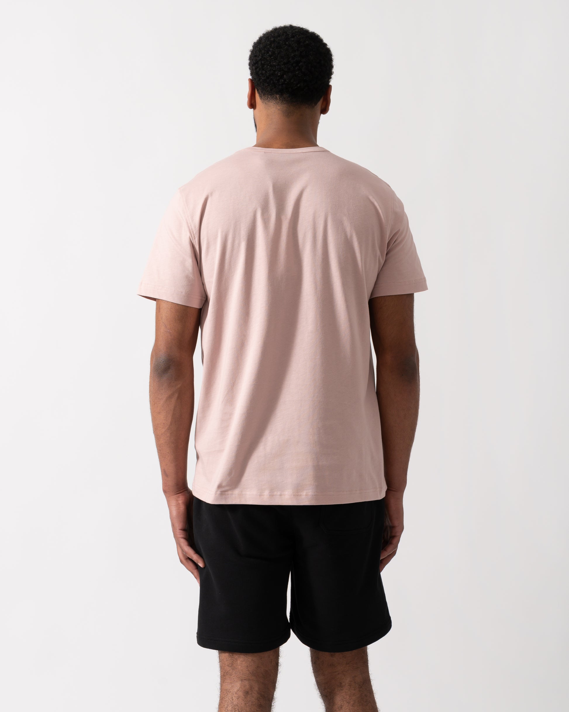 Back shot of a Model wearing a Belstaff Short Sleeved Mens Logo Patch T-Shirt  in Dusk Pink