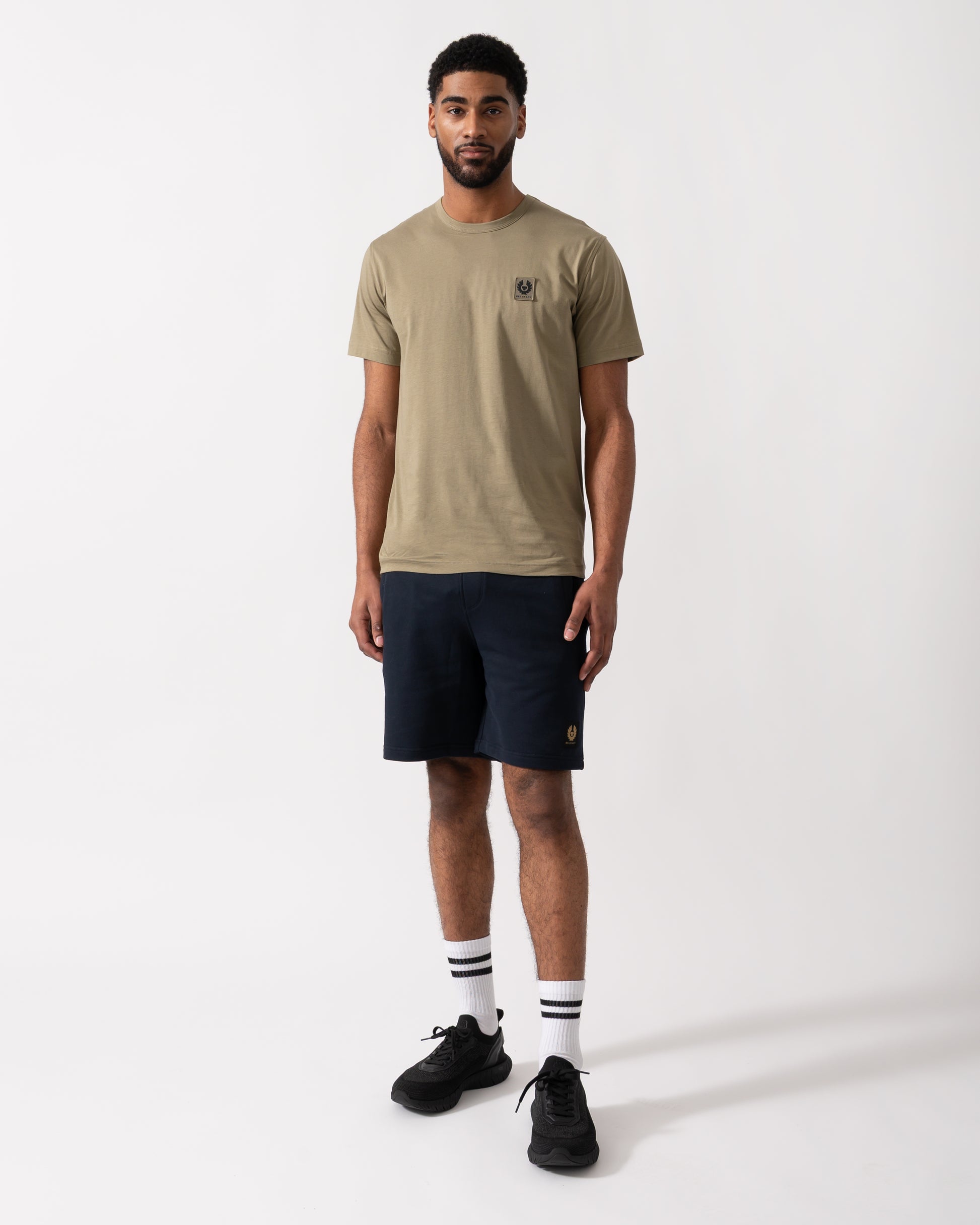 Full length shot of a Model wearing a Belstaff Short Sleeved Mens Logo Patch T-Shirt in Fatigue Green