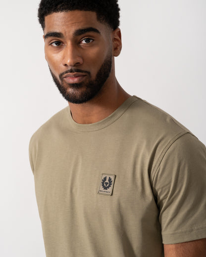 Close up shot of a Model wearing a Belstaff Short Sleeved Mens Logo Patch T-Shirt in Fatigue Green