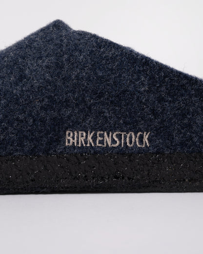 Studio photograph showing a logo detail of Birkenstock Zermatt Shearling FE Womens Clogs  Dark Bluen