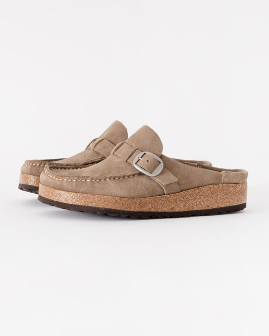 Pair of beige loafers with cork sole on a white background