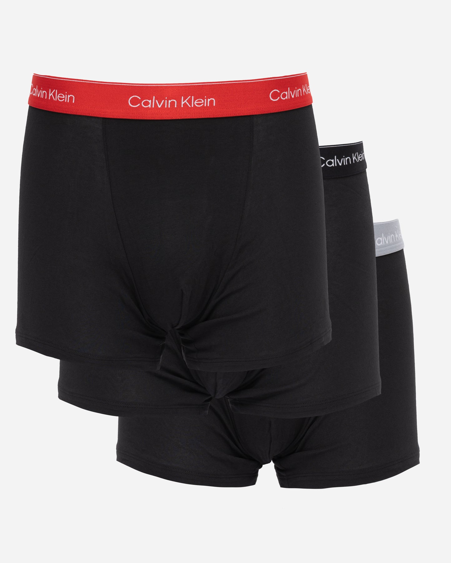 studio shot of Calvin Klein 3 Pack Icon Cotton Stretch Mens Relaxed Fit Trunks in Black with red, black and silver waistbands