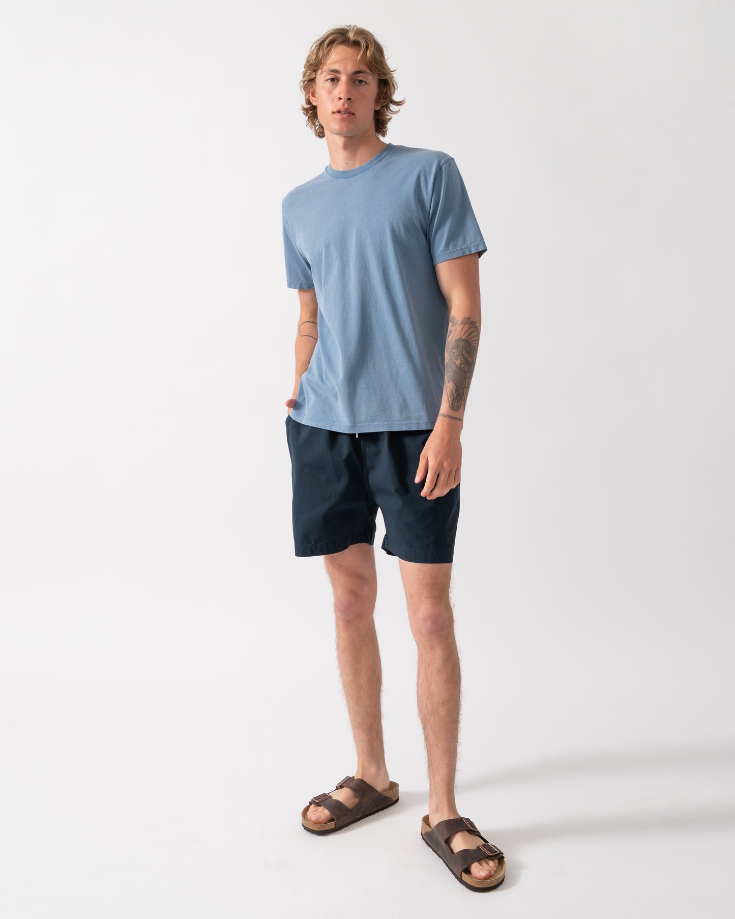 full length shot of a model wearing a Colorful Standard Classic Organic T-Shirt in Faded Indigo