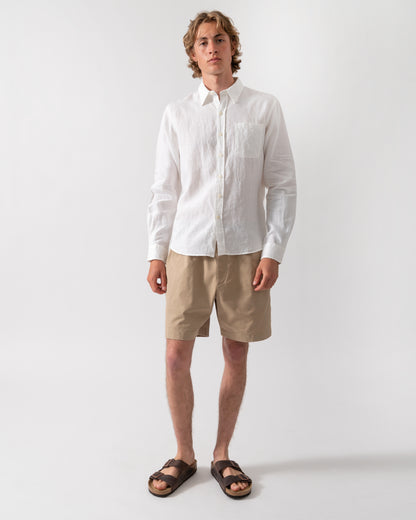 full length shot of a model wearing a Colorful Standard Mens Long Sleeve Linen Shirt in Optical White