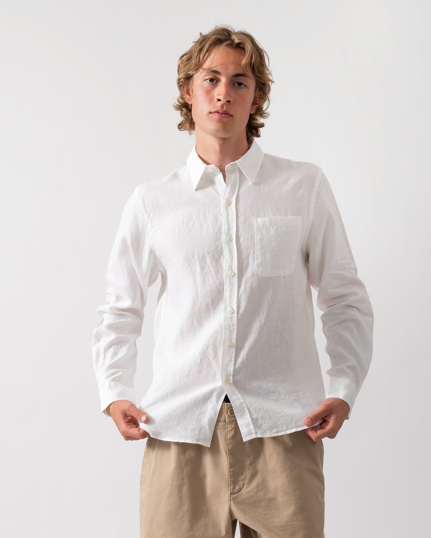 model wearing a Colorful Standard Mens Long Sleeve Linen Shirt in Optical White