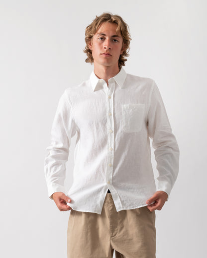 model wearing a Colorful Standard Mens Long Sleeve Linen Shirt in Optical White