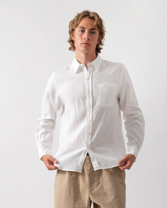 model wearing a Colorful Standard Mens Long Sleeve Linen Shirt in Optical White