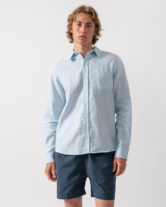Model wearing a Colorful Standard Mens Long Sleeve Linen Shirt in Polar Blue