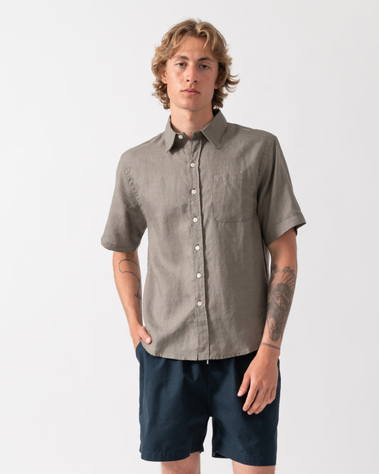model wearnig a Colorful Standard Mens Short Sleeve Linen Shirt in Dusty Olive