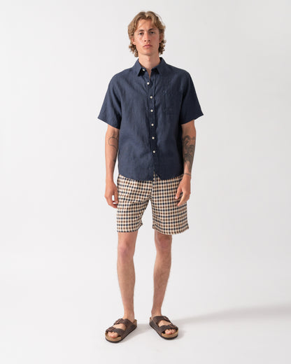 full length shot of a model wearing a Colorful Standard Mens Short Sleeve Linen Shirt in Navy Blue