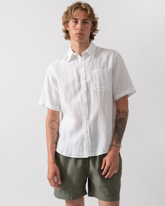 model wearing a Colorful Standard Mens Short Sleeve Linen Shirt in Optical White