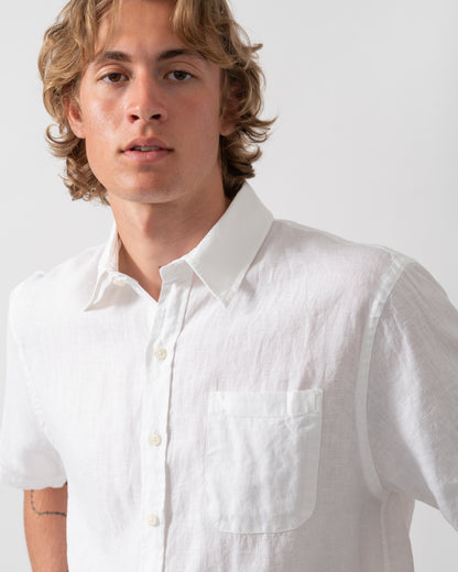 close up shot of a model wearing a Colorful Standard Mens Short Sleeve Linen Shirt in Optical White