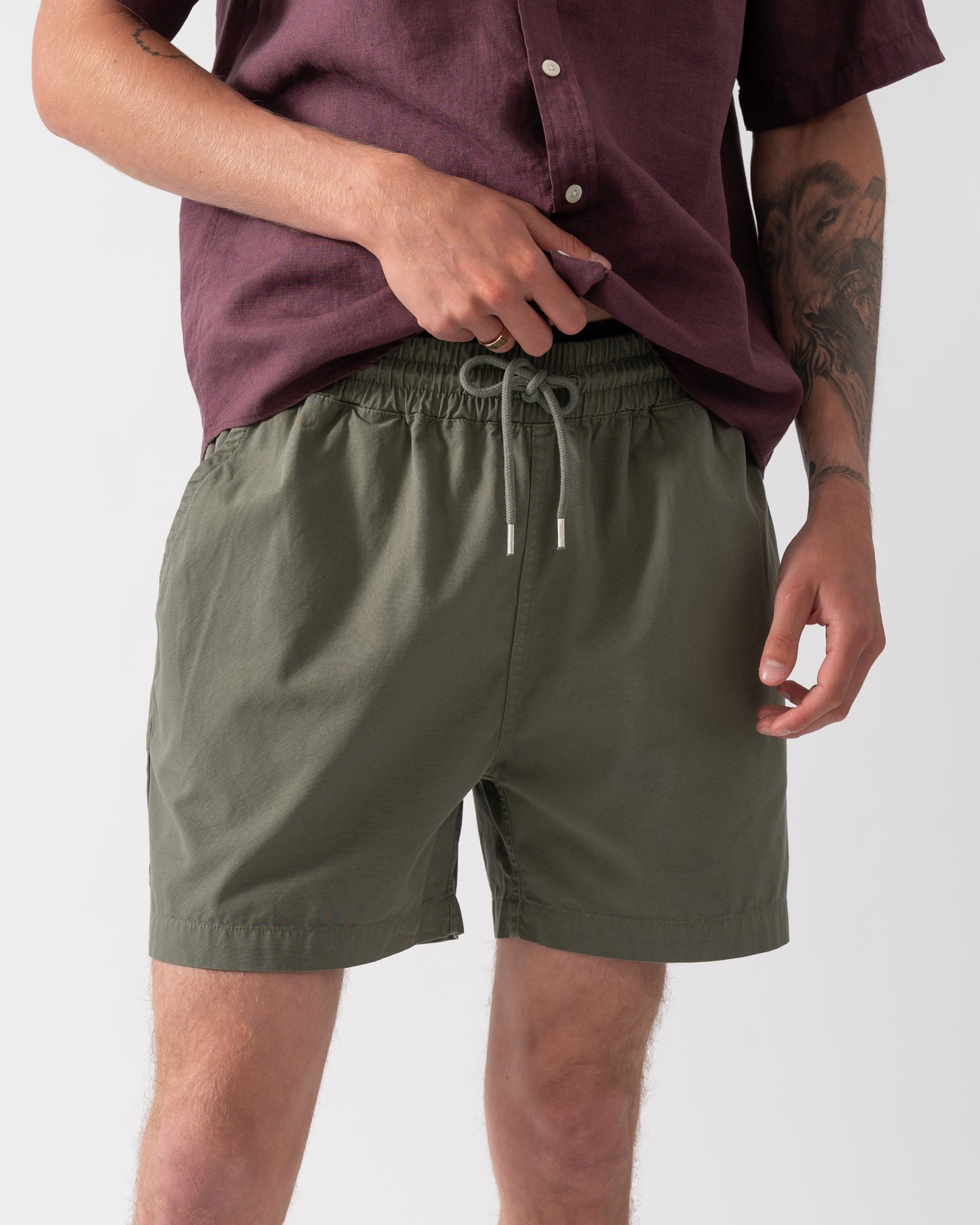 close up shot of model wearing Colorful Standard Organic Twill Shorts in Dusty Olive