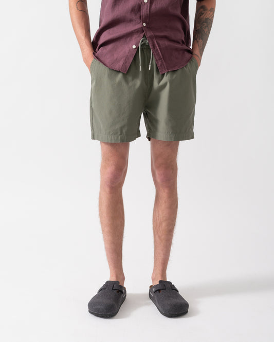 model wearing Colorful Standard Organic Twill Shorts in Dusty Olive
