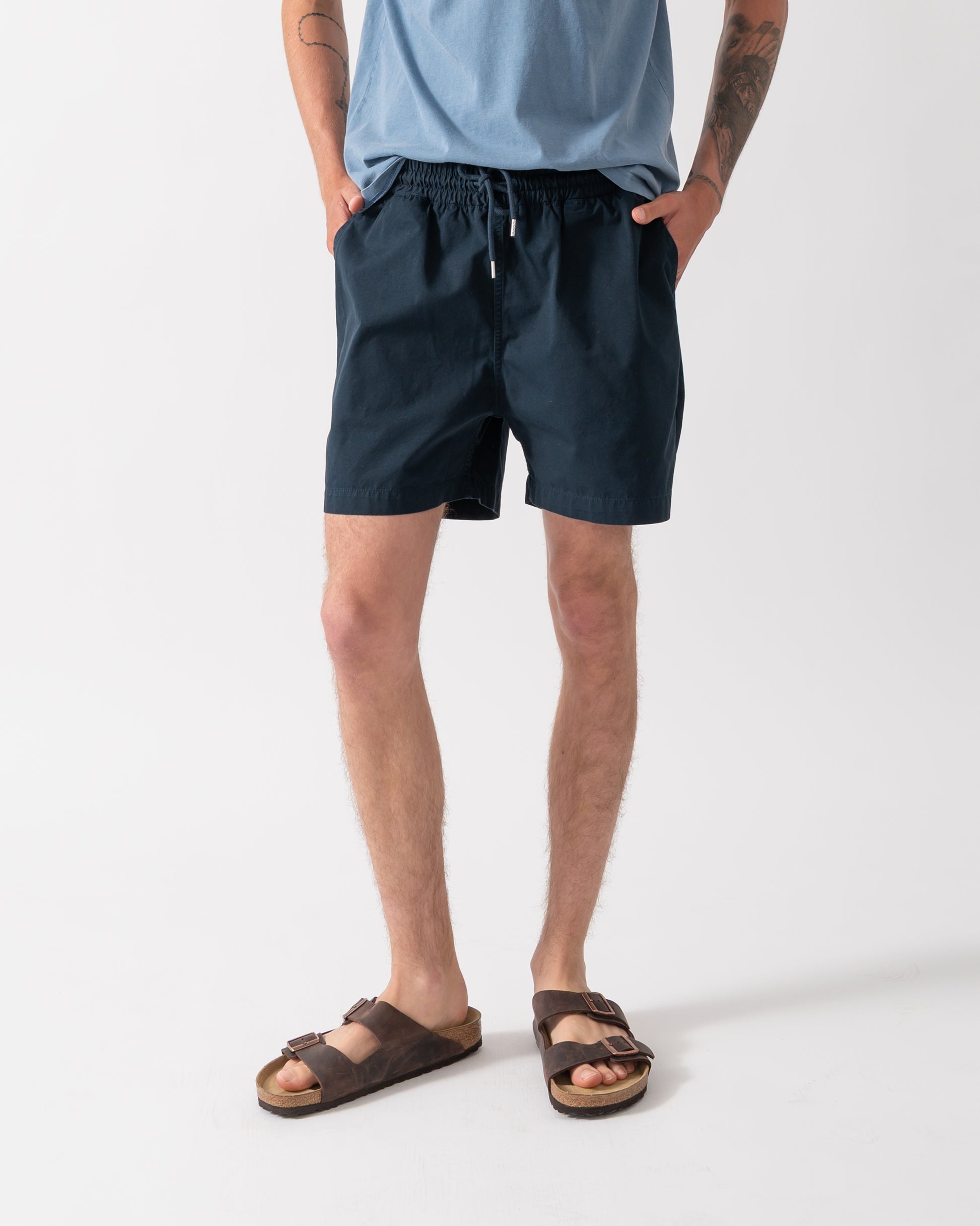 model wearing Colorful Standard Organic Twill Shorts in Navy Blue