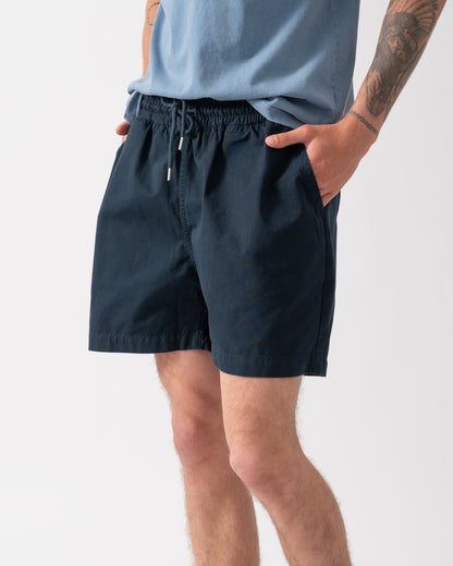 close up of model wearing Colorful Standard Organic Twill Shorts in Navy Blue