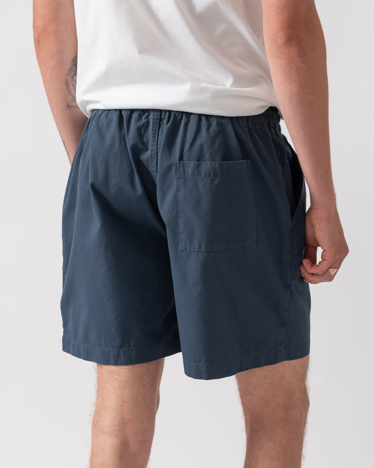 back shot of model wearing Colorful Standard Organic Twill Shorts in Petrol Blue