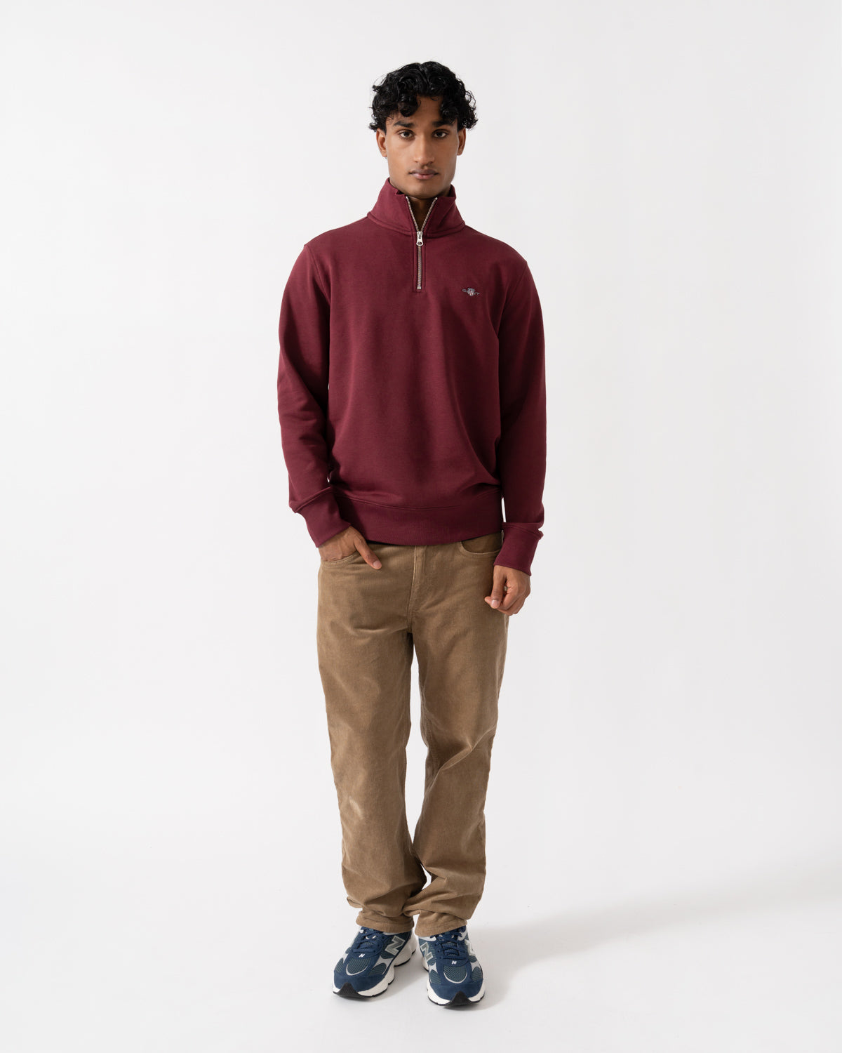 Man wearing the GANT Mens Regular Fit Shield Logo Half Zip Sweatshirt - 676 Deep Grape Wine