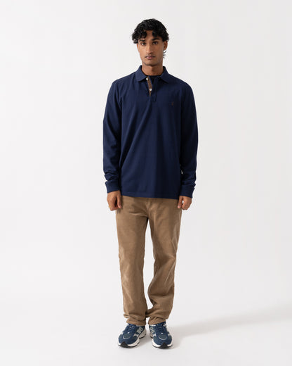 Man wearing the Joules Woody Mens Long Sleeve Polo Shirt - Navy