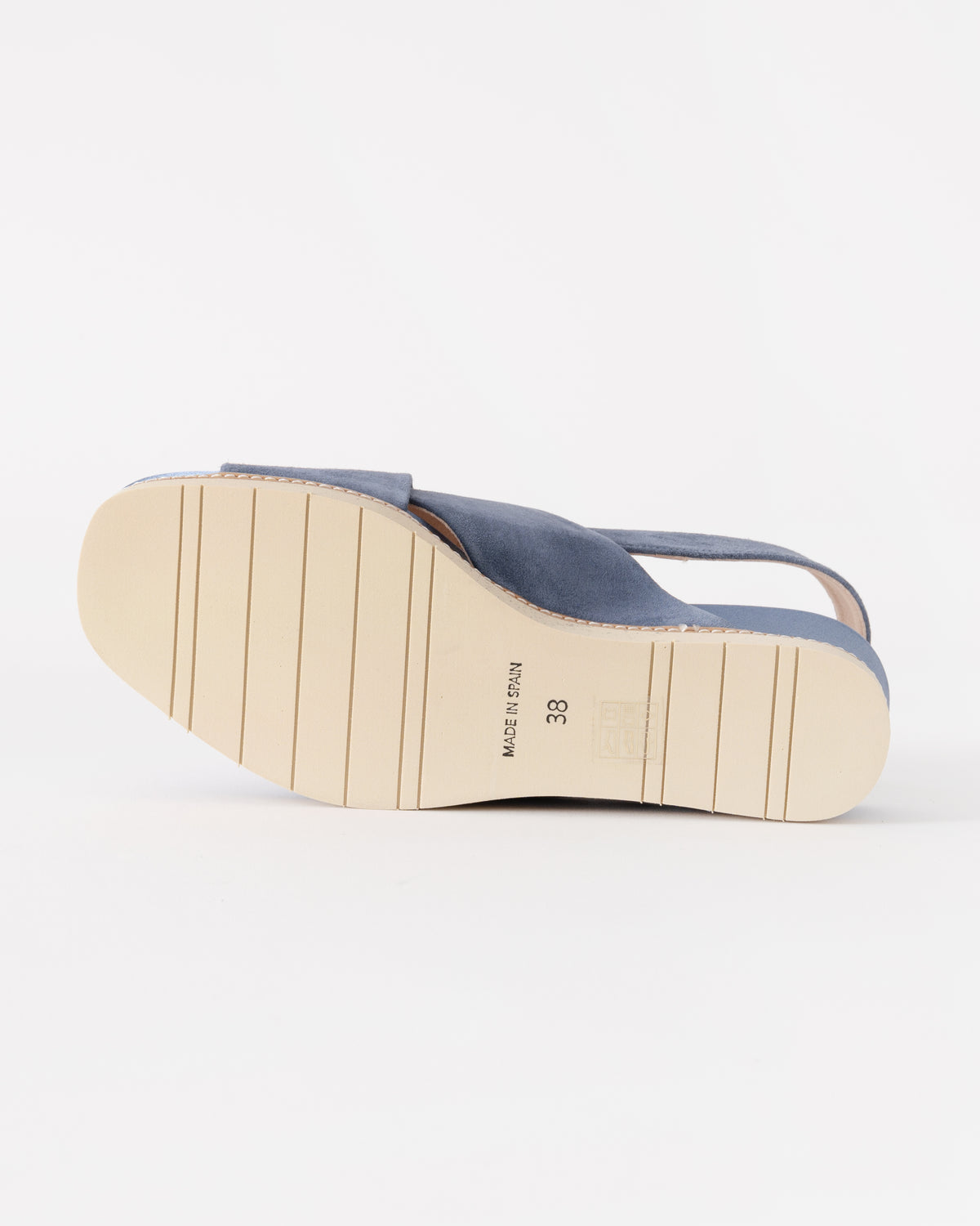 Blue sandal with a white sole on a light gray background