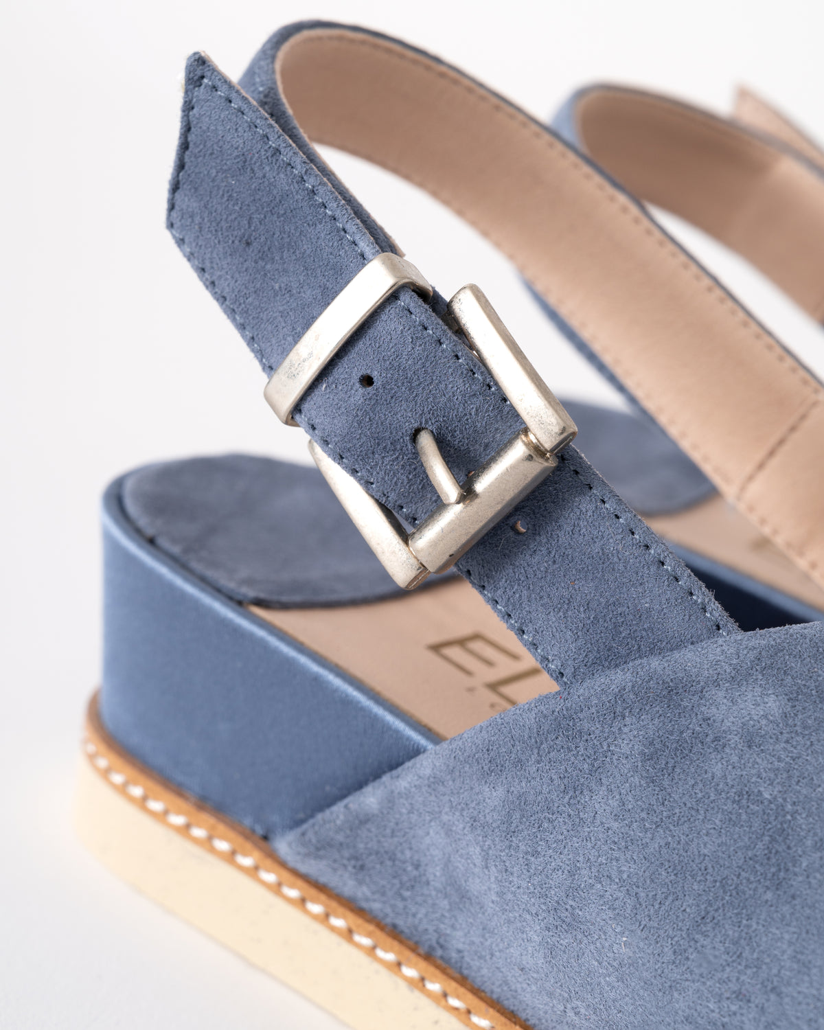Blue sandal with a buckle on a white background