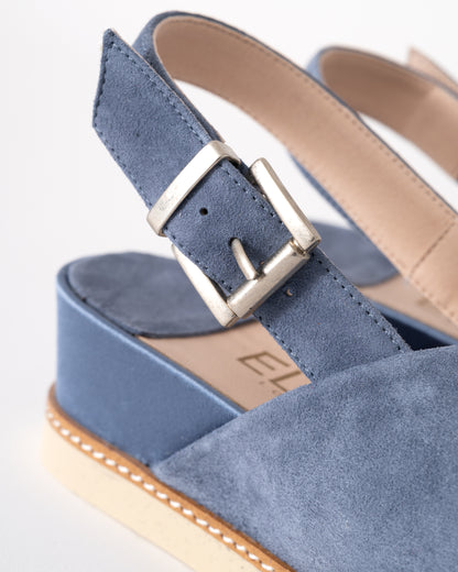 Blue sandal with a buckle on a white background