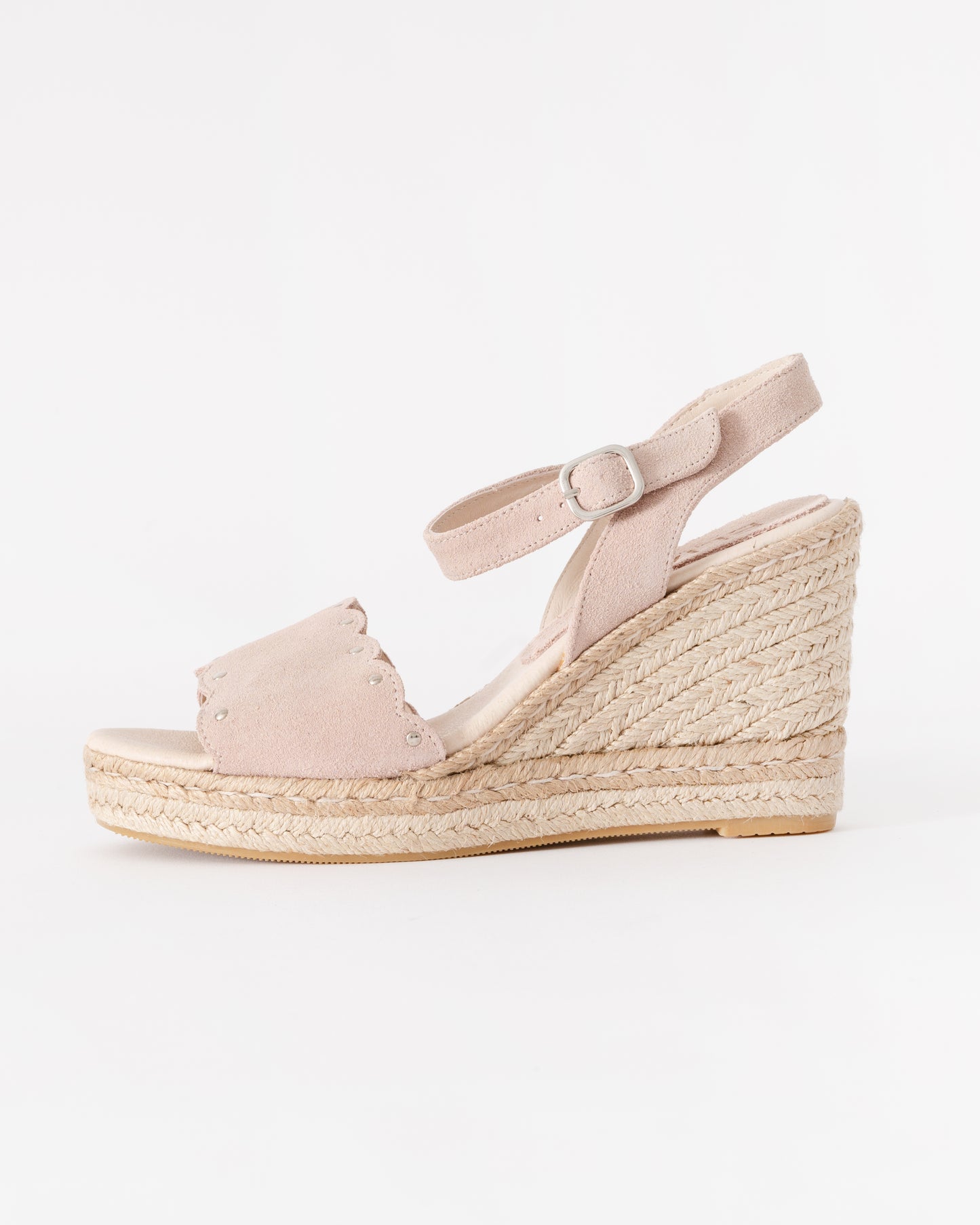 Pink wedge sandal with espadrille sole on a white background