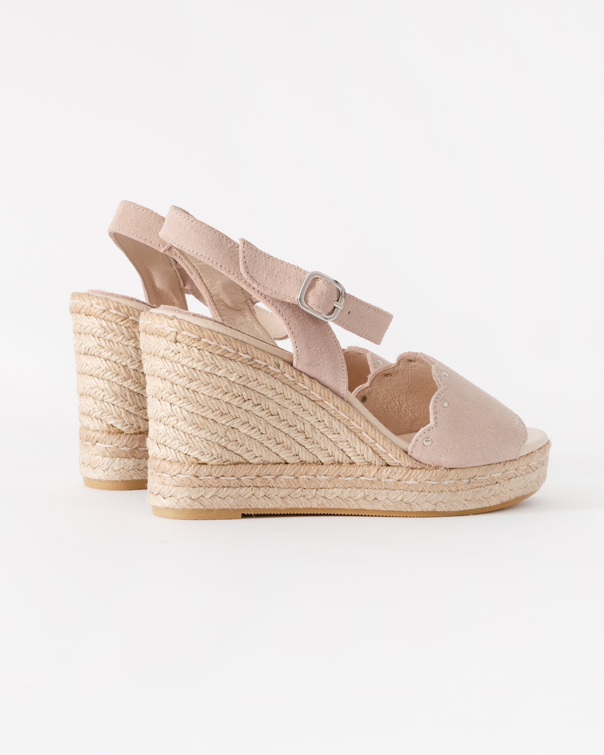 Pink wedge sandal with espadrille sole on a white background