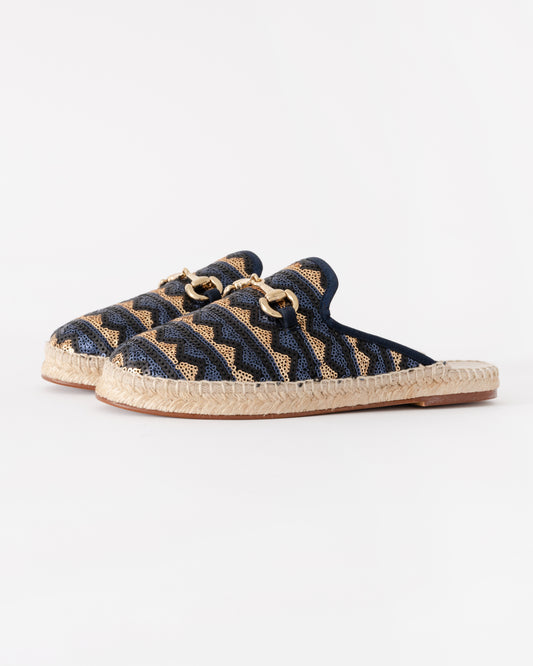 Pair of navy blue espadrilles with beige sole on a white background
