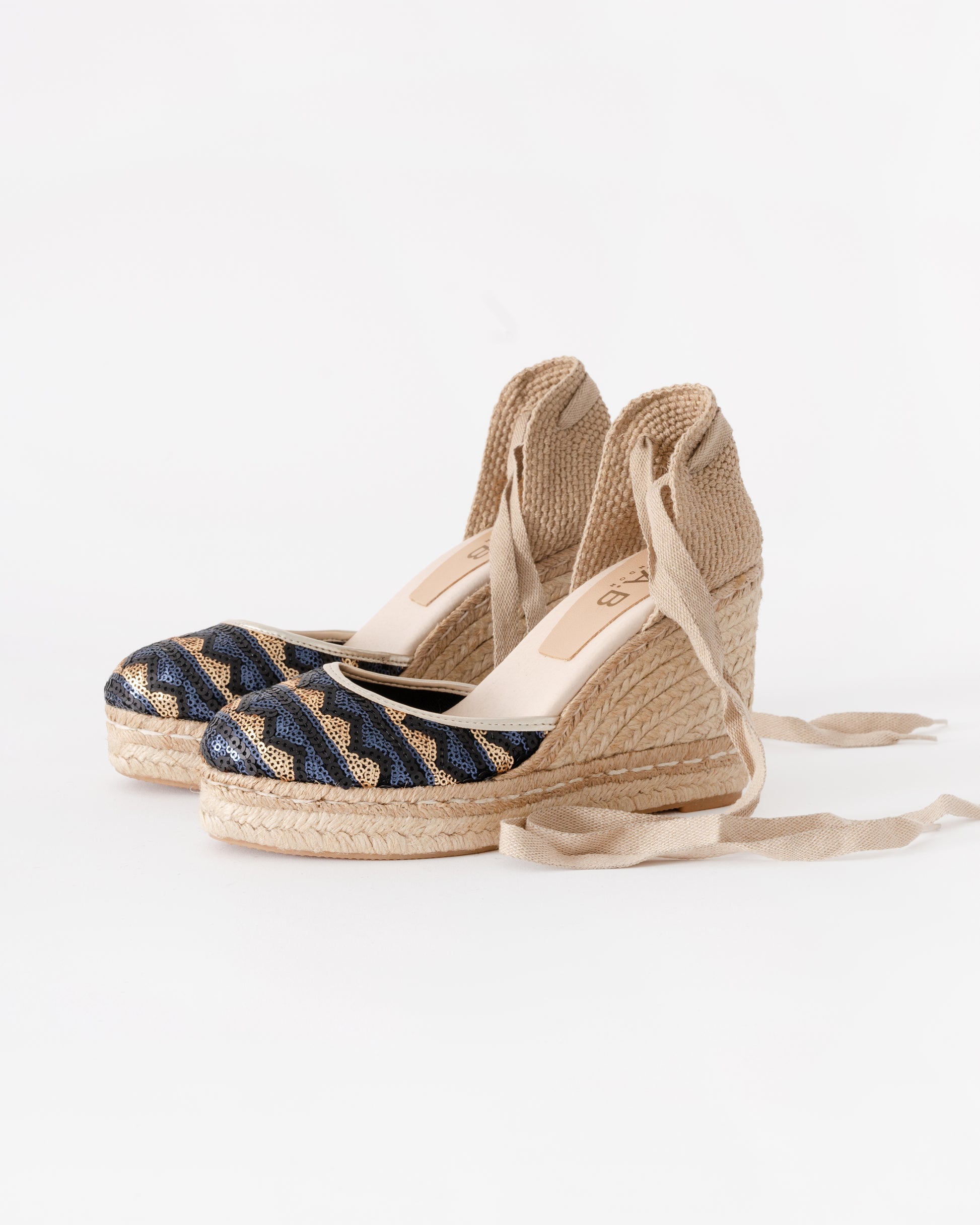 Pair of wedge sandals with jute sole on a white background