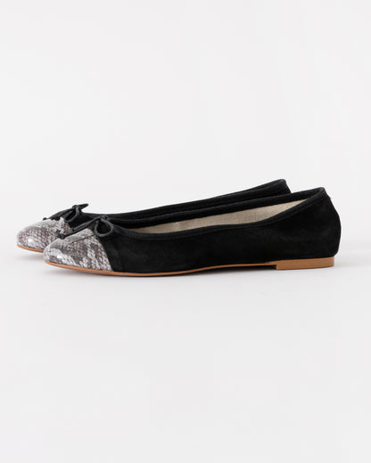 Black flats with glittery toe caps on a white background