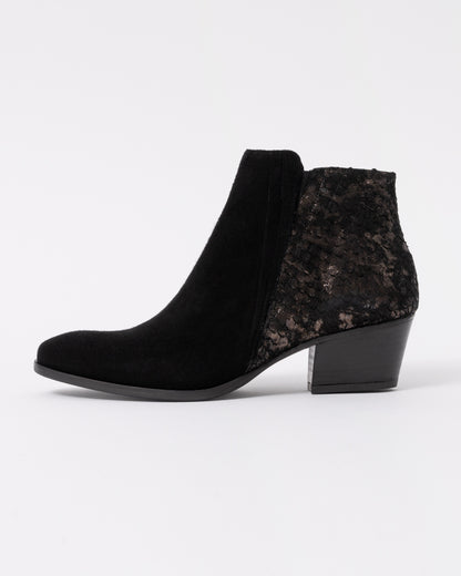 Black ankle boots with a textured pattern on a white background