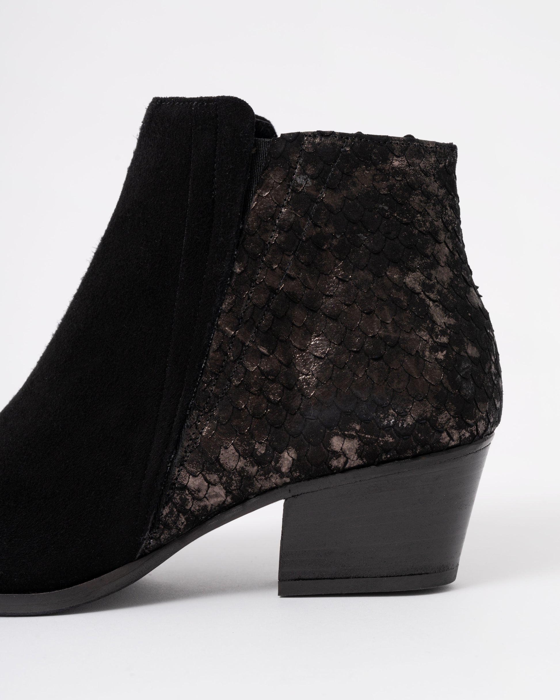 Black textured ankle boot on a white background