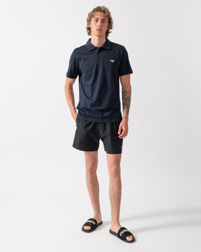 full length shot of a model wearing an Emporio Armani Mens Beach Polo with Eagle Logo in Armani Blue