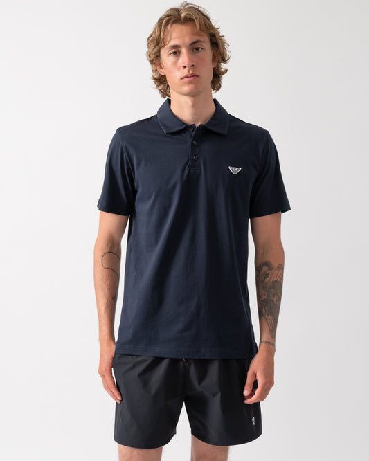 model wearing an Emporio Armani Mens Beach Polo with Eagle Logo in Armani Blue