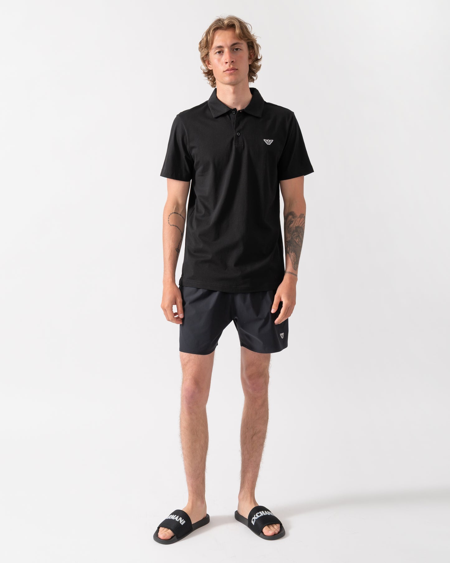 full length shot of a model wearing an Emporio Armani Mens Beach Polo with Eagle Logo in Black