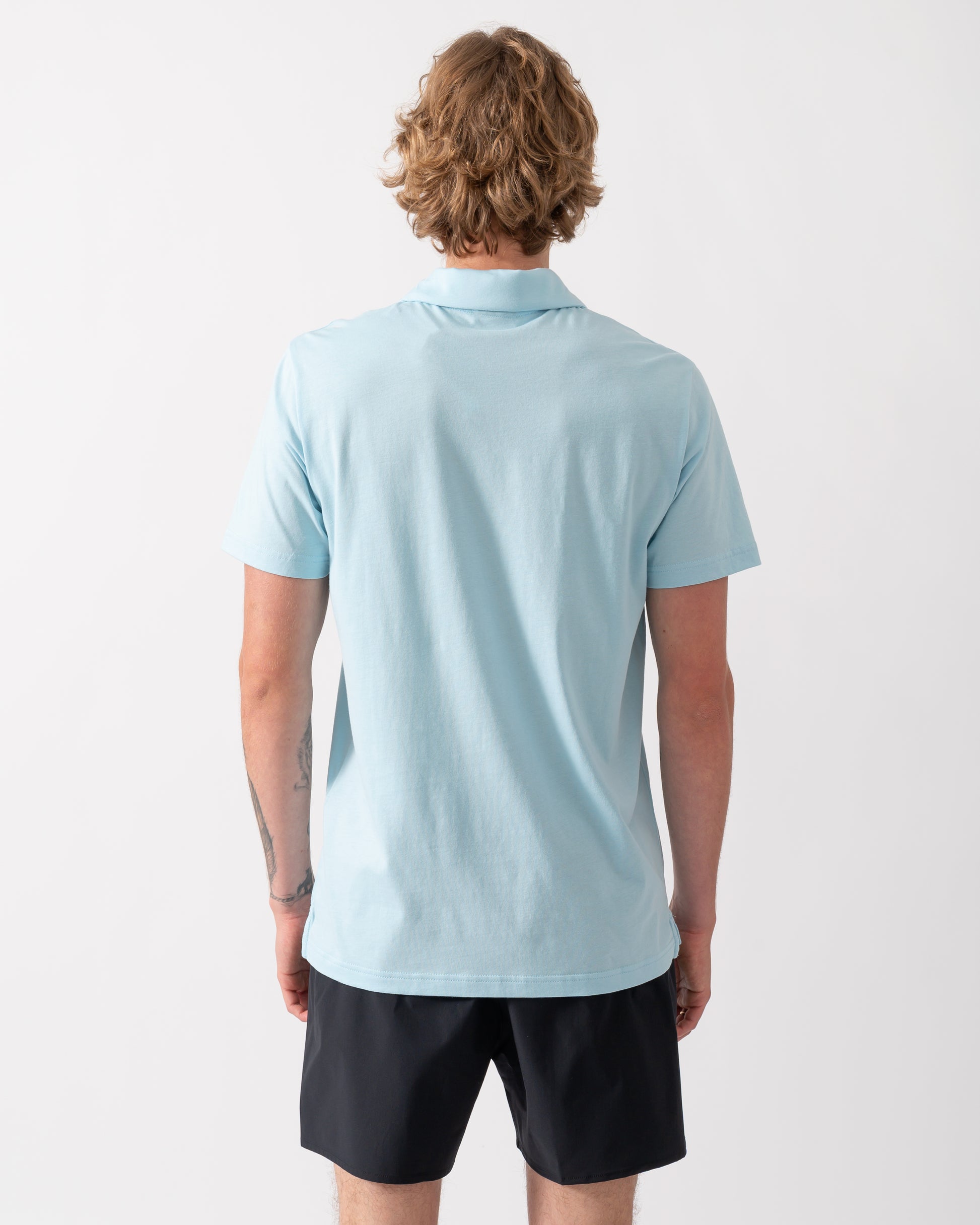 back of a model wearing an Emporio Armani Mens Beach Polo with Eagle Logo in Sky blue