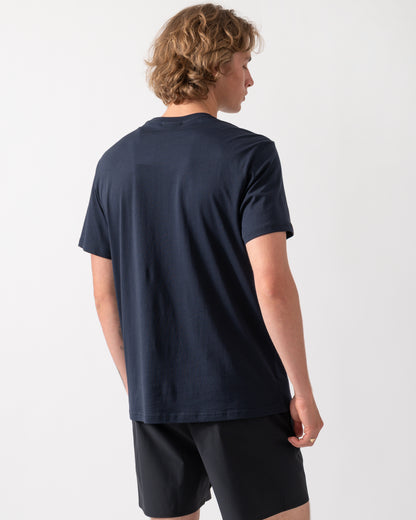 back shot of a model wearing an Emporio Armani Mens Beach T-Shirt with Eagle Logo in Armani Blue