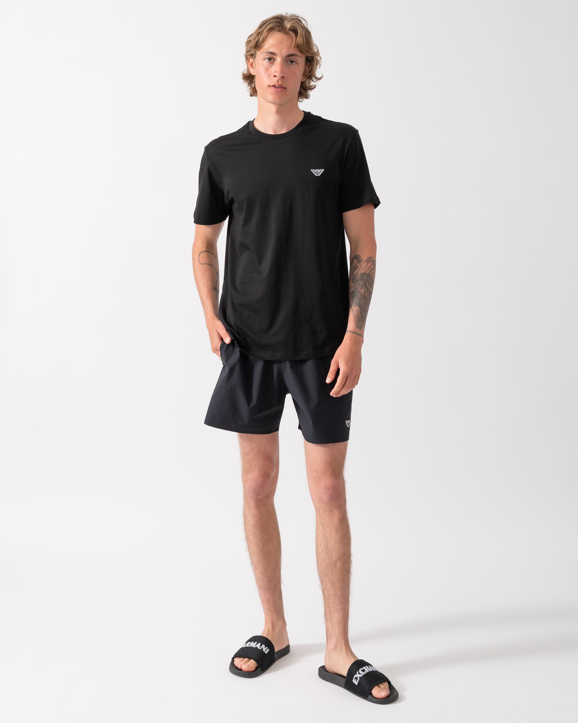full length shot of a model wearing an Emporio Armani Mens Beach T-Shirt with Eagle Logo in Black