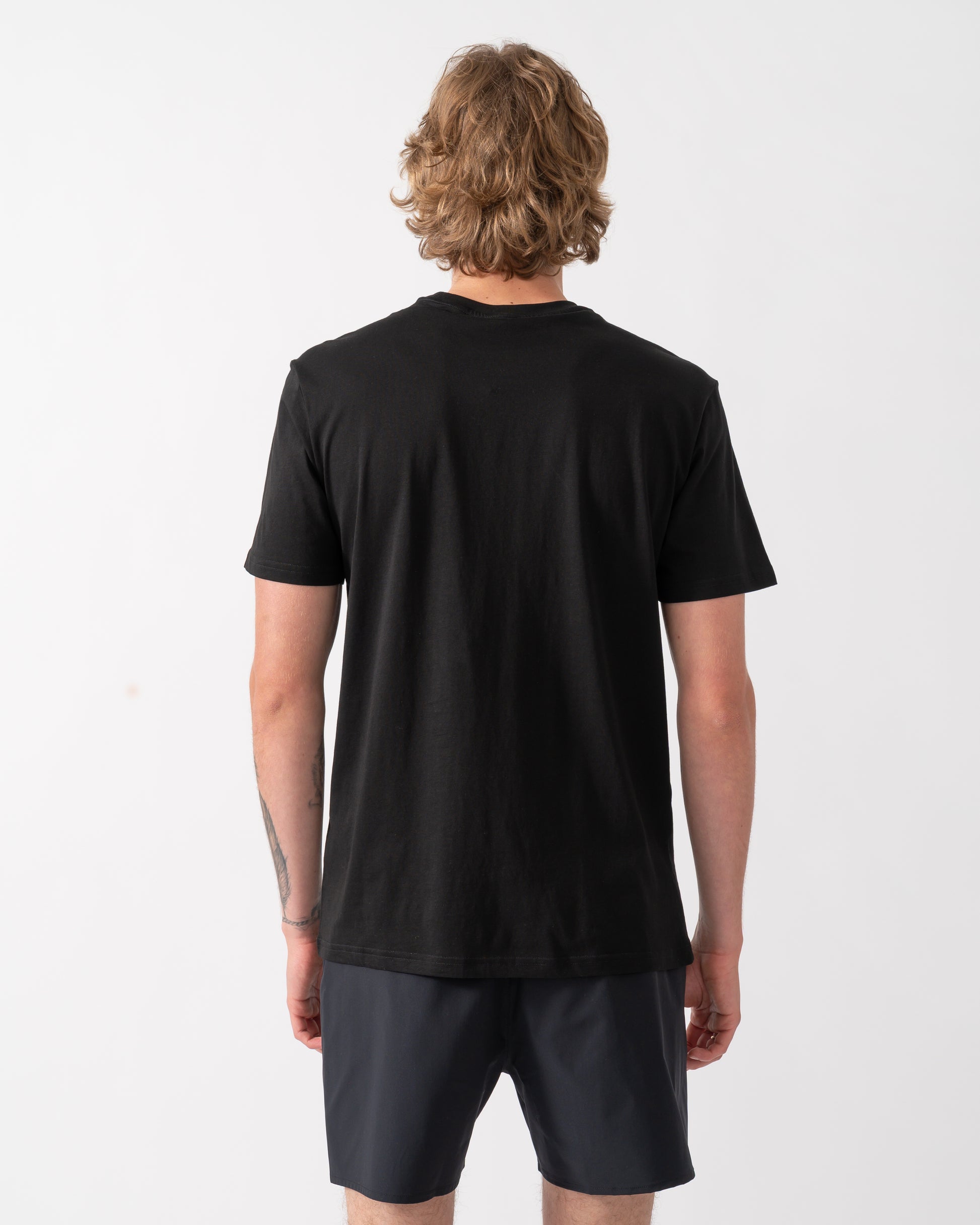 back of a model wearing an Emporio Armani Mens Beach T-Shirt with Eagle Logo in Black