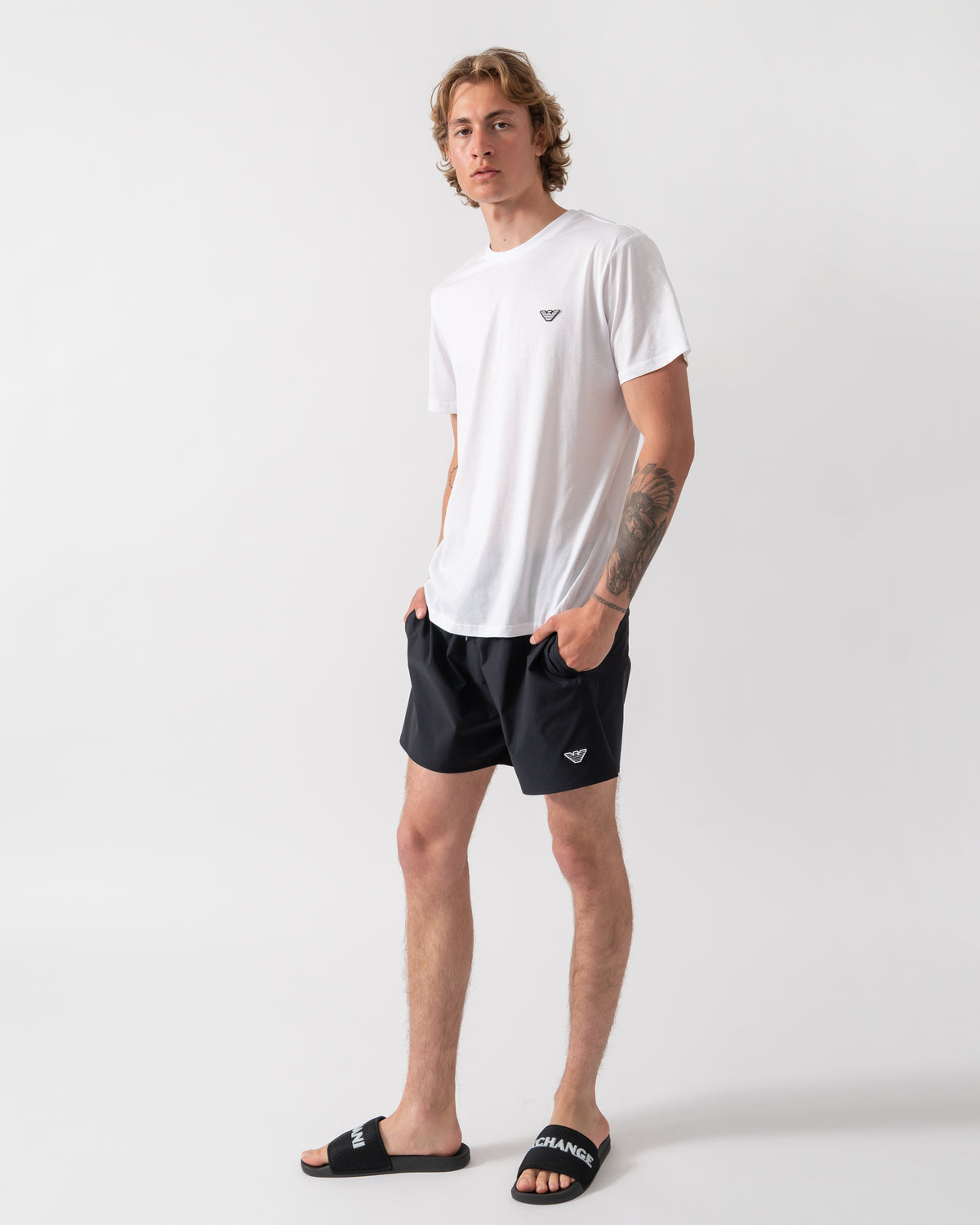 full length shot of a model wearing an Emporio Armani Mens Beach T-Shirt with Eagle Logo in White