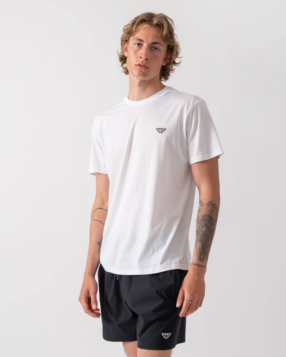 model wearing an Emporio Armani Mens Beach T-Shirt with Eagle Logo in White