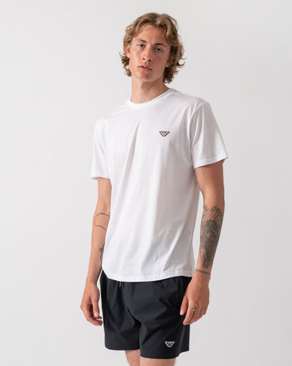 model wearing an Emporio Armani Mens Beach T-Shirt with Eagle Logo in White
