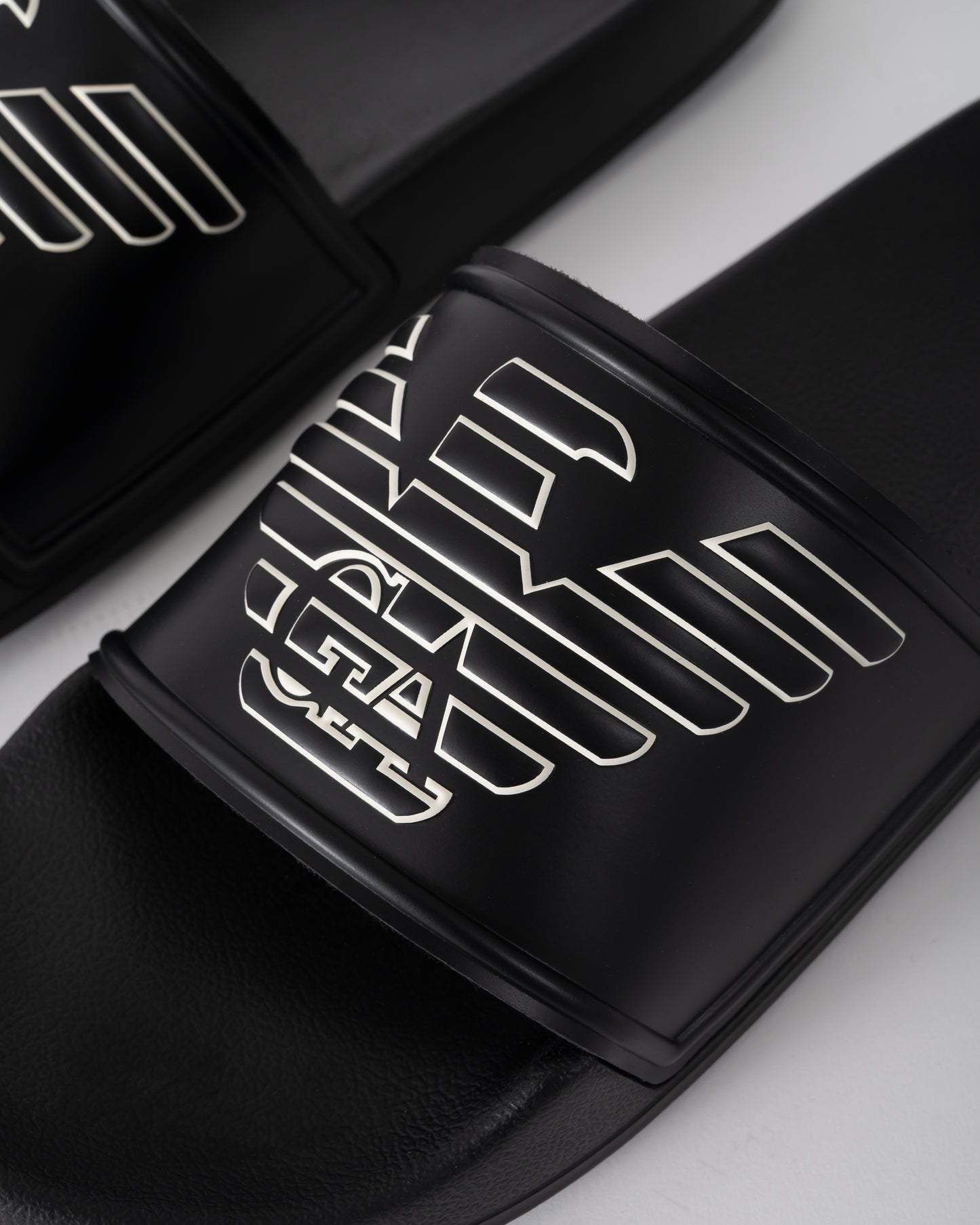 logo detail of Emporio Armani Mens PVC Pool Slides with Eagle Logo in Black and Whisper White
