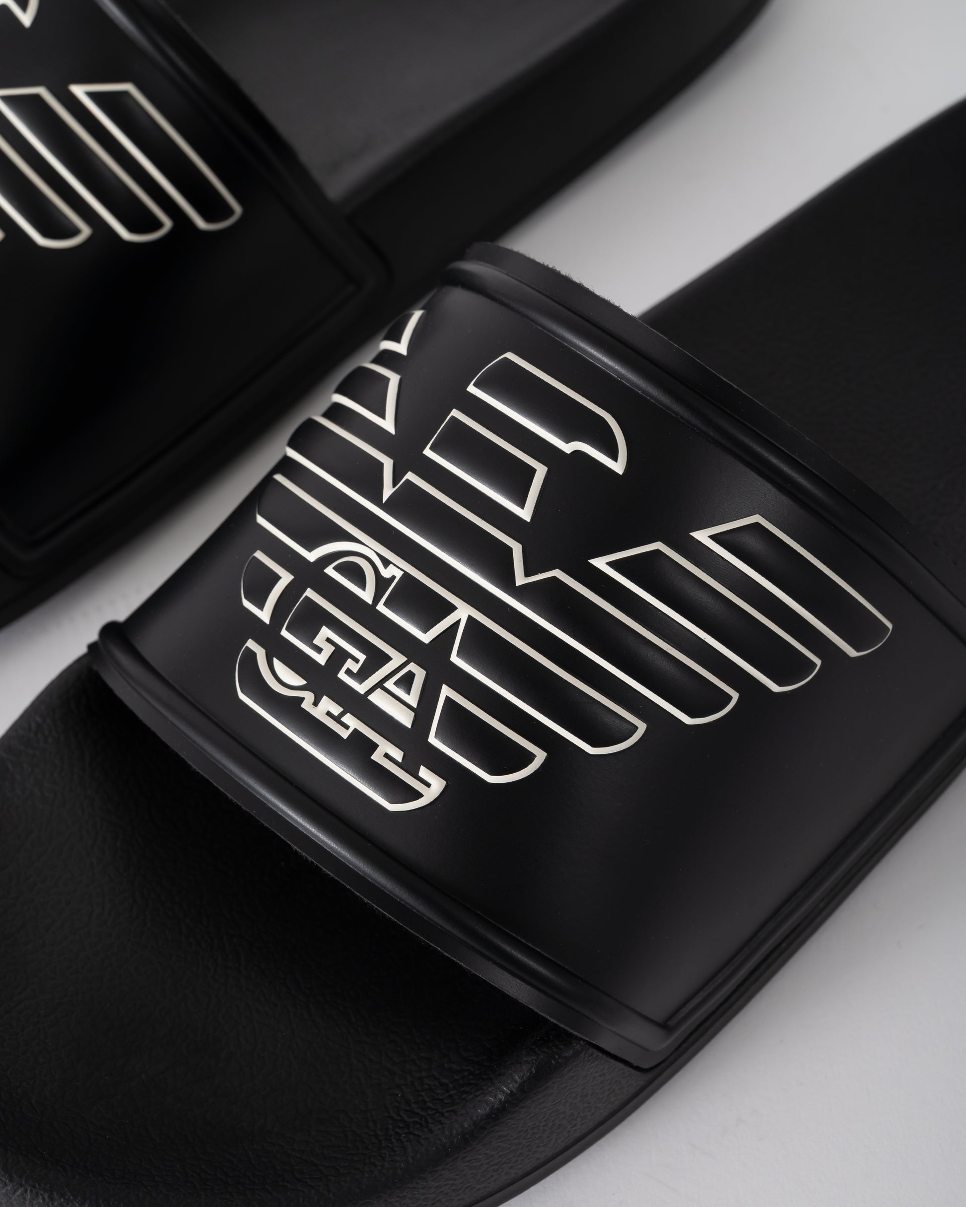 logo detail of Emporio Armani Mens PVC Pool Slides with Eagle Logo in Black and Whisper White