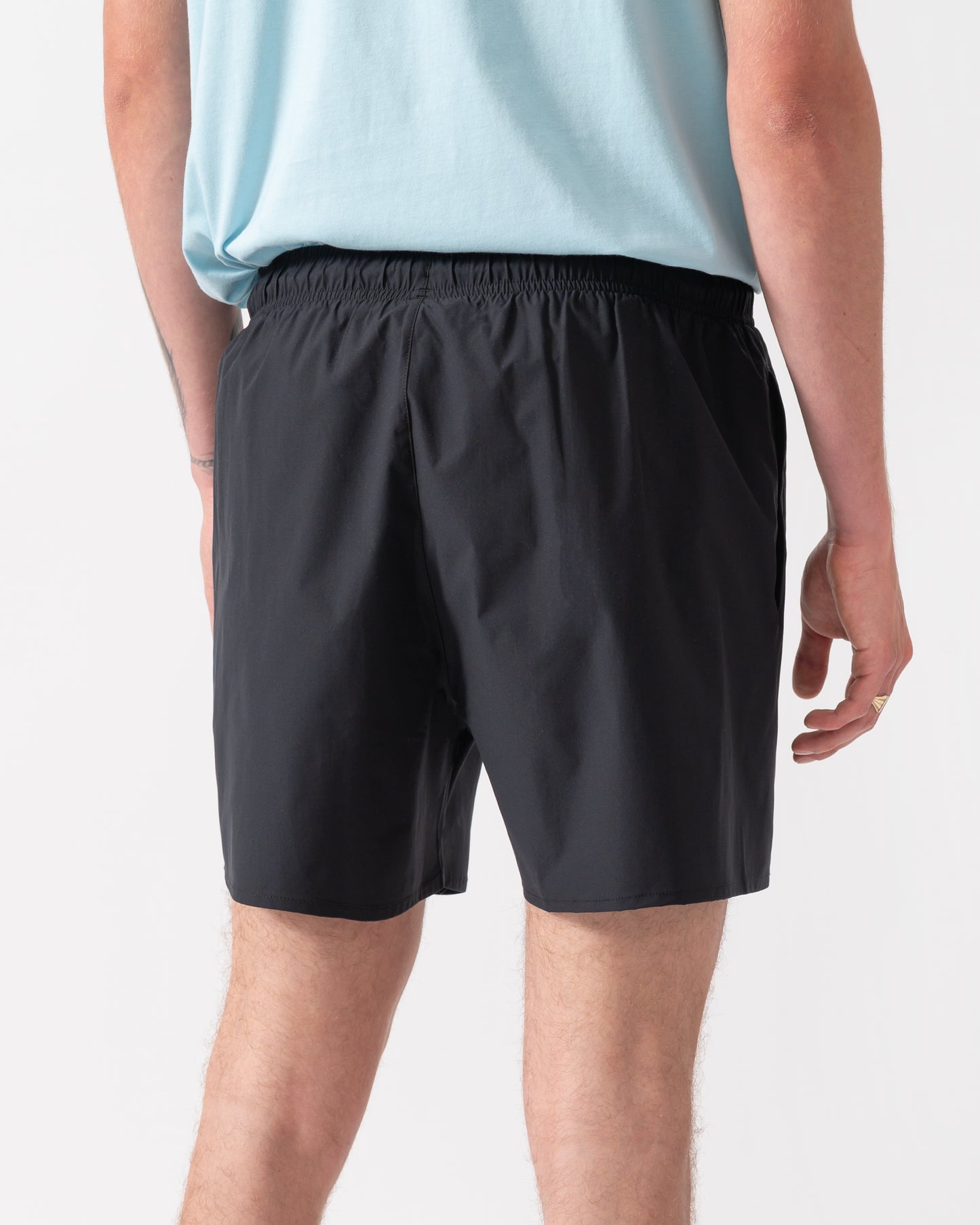 model wearing a pai of Emporio Armani Mens Swim Shorts with Eagle Logo in Black