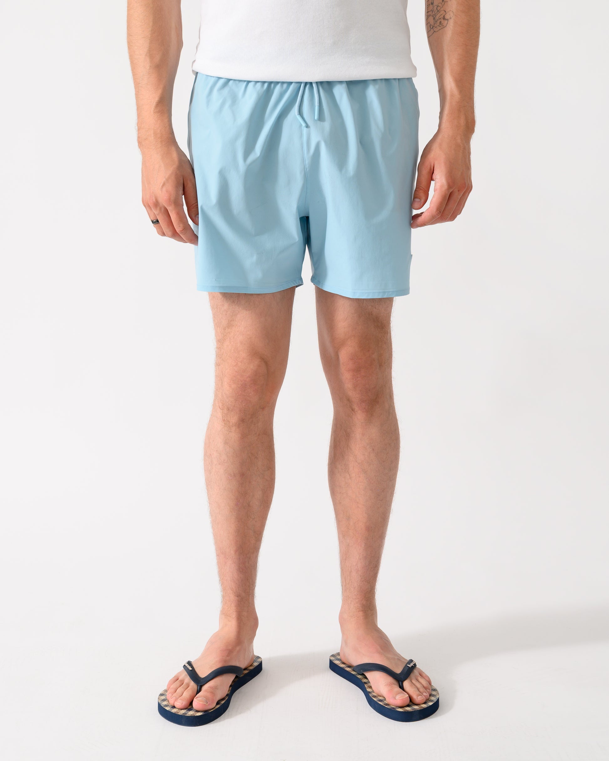 front shot of a model wearing a pair of Emporio Armani Mens Swim Shorts with Eagle Logo in Sky