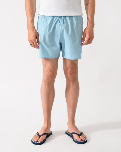 front shot of a model wearing a pair of Emporio Armani Mens Swim Shorts with Eagle Logo in Sky