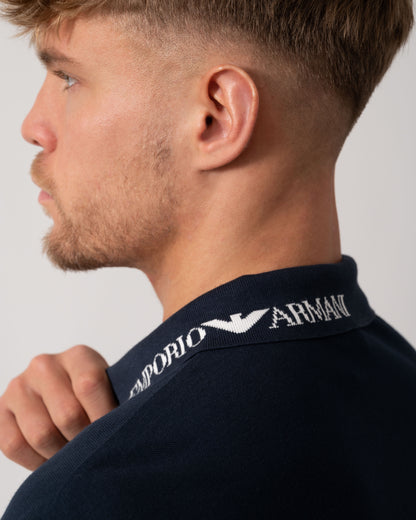 Model wearing Emporio Armani Mens Beach Polo in Armani Blue - Logo detail